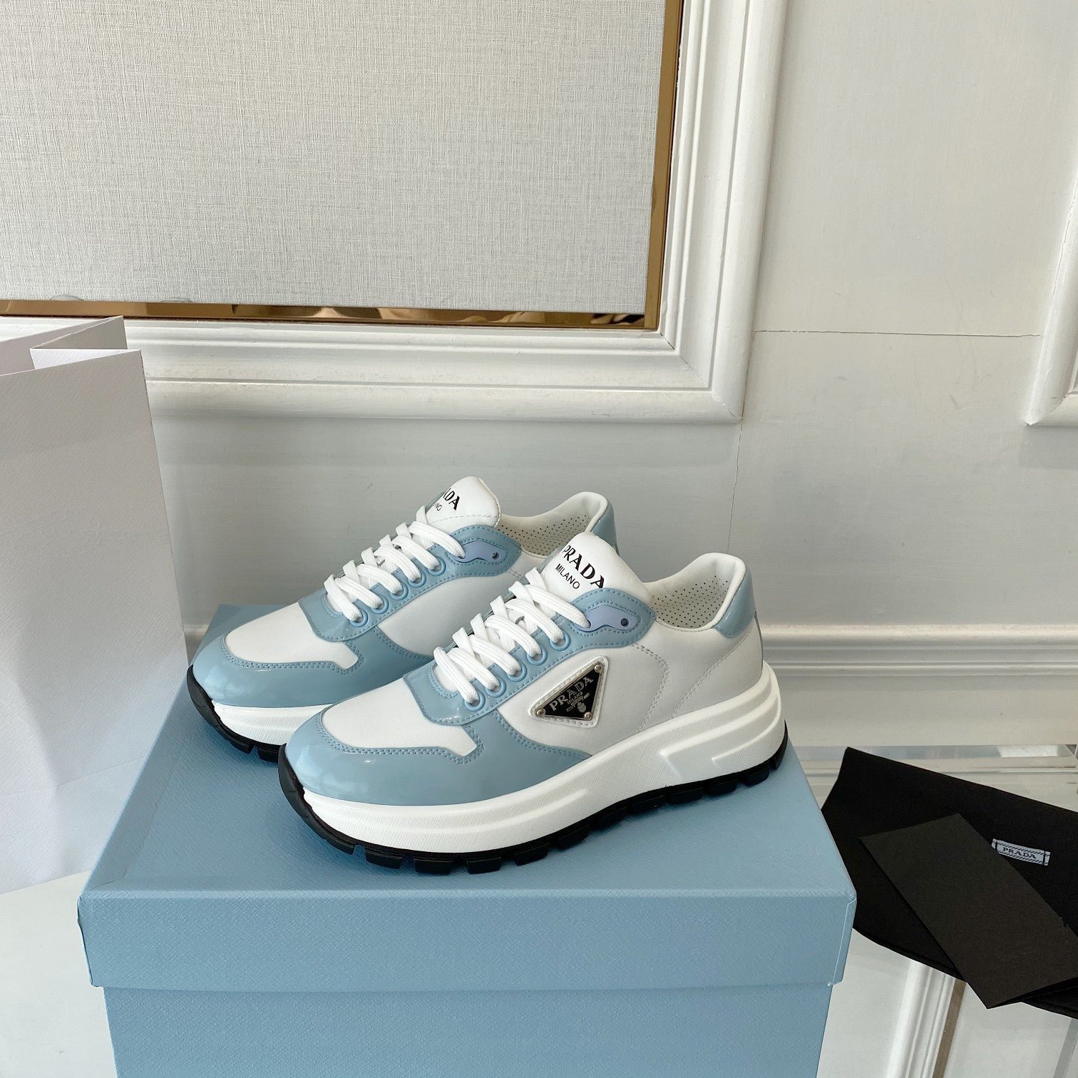 PRADA 25S THICK SOLE SNEAKER IN WHITE AND LIGHT BLUE CALFSKIN